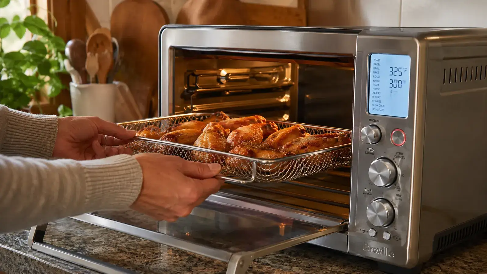 Close-up of the Breville BOV900 interior with a wire rack holding air-fried chicken wings